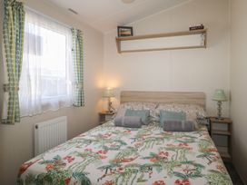 A bedroom with a bed and bedside table at Tower View Number 34 in Pevensey