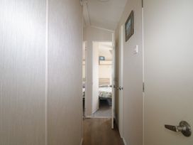 A hallway with doors leading to a bedroom at Tower View Number 34 Pevensey