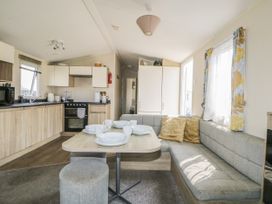 A kitchen with a couch and dining area at Tower View Number 34 Pevensey Bay