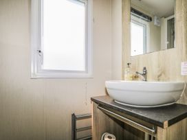 A bathroom with a sink and hand soap at Tower View Number 34 Pevensey Bay