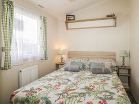 A bedroom with a bed and bedside table at Tower View Number 34 Pevensey Bay