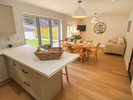 A kitchen and dining area with a table and chairs at Hafan Y Gof Newcastle Emlyn