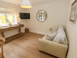 A sitting room with a sofa and a table at Hafan Y Gof in Newcastle Emlyn