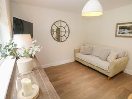 A living room with a sofa and television at Hafan Y Gof in Newcastle Emlyn