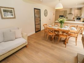 A dining room with a table set for dinner at Hafan Y Gof Newcastle Emlyn