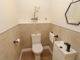 A bathroom with a toilet and sink at Hafan Y Gof in Newcastle Emlyn