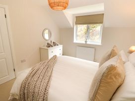 A bedroom with a bed and dresser at Hafan Y Gof in Newcastle Emlyn