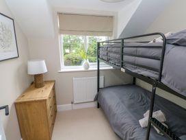 A bedroom with a bunk bed and a dresser at Hafan Y Gof in Newcastle Emlyn