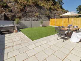 A garden with a hot tub and seating area at Hafan Y Gof Newcastle Emlyn
