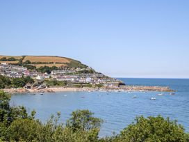 A beach view with boats and houses at Hafan Y Gof Newcastle Emlyn
