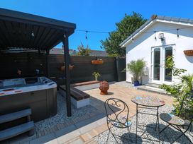 A garden with a hot tub and seating area at Carn Brea in Redruth