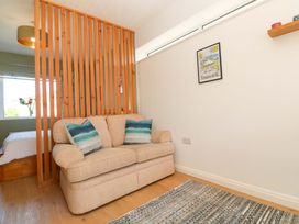 A living room with a sofa and wall art at Carn Brea in Redruth