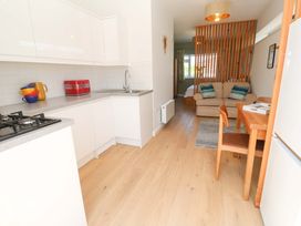 A kitchen with a dining area and sofa at Carn Brea in Redruth