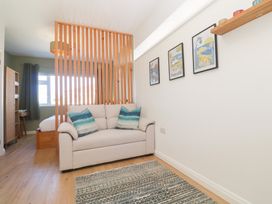 A living room with a sofa and wall art at Carn Brea in Redruth