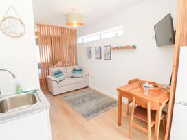 A living room with a sofa and dining table at Carn Brea Redruth