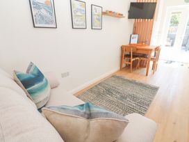A living room with a sofa and dining area at Carn Brea in Redruth