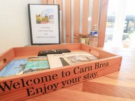 A welcome tray with books and a remote control at Carn Brea in Redruth