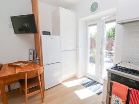 A kitchen with a table and chairs and a refrigerator at Carn Brea in Redruth