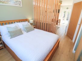 A bedroom with a bed and divider at Carn Brea Redruth