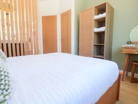 A bedroom with a bed and wardrobe at Carn Brea in Redruth