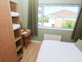 A bedroom with a bed and shelf at Carn Brea in Redruth