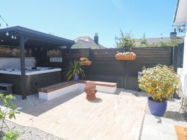 An outdoor area with a hot tub and seating at Carn Brea in Redruth
