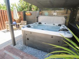 An outdoor space with a hot tub and seating area at Carn Brea, Redruth