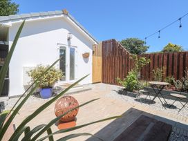 An outdoor area with plants and tables at Carn Brea in Redruth