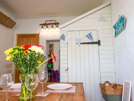 A dining room with a table set and floral arrangement at 3 The Old Cornstore