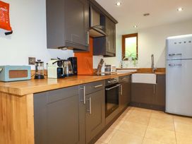 A kitchen with modern appliances and cabinetry at 3 The Old Cornstore