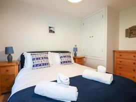 A bedroom with a bed and bedside tables at 3 The Old Cornstore