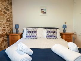 A bedroom with a bed and bedside tables at 3 The Old Cornstore