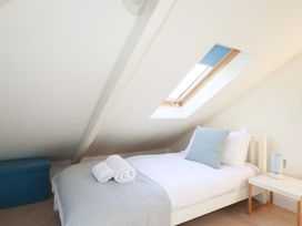 A bedroom with a bed and skylight at 3 The Old Cornstore