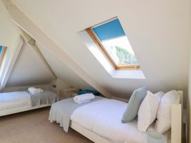 A bedroom with two beds and a skylight at 3 The Old Cornstore