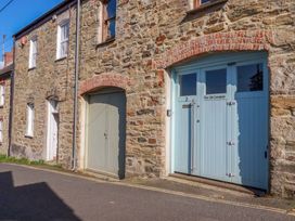 An exterior view of a stone building with two doors at 3 The Old Cornstore St Agnes