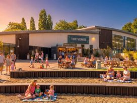 An outdoor seating area with people at The Venue in Billing Aquadrome Holiday Park
