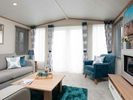 A living room with a sofa and armchair at Aquadrome Abode 3bed - Billing Aquadrome