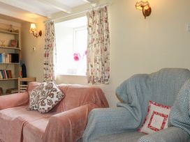 A living room with a sofa and armchair at Trevean in Bude