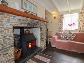 A living room with a fireplace and couch at Trevean in Bude