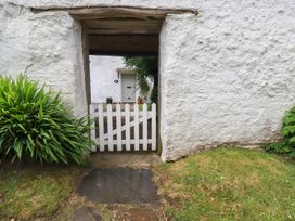 A view of a white gate and door at Trevean in Bude
