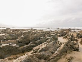 A beach with rocks and ocean waves at Trevean in Crackington Haven