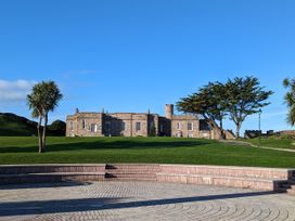 A building with trees and grass outside at Trevean in Crackington Haven