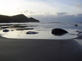 A beach with rocks and water at Trevean in Crackington Haven