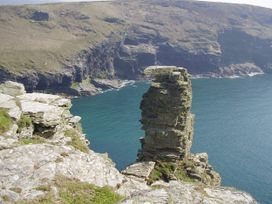 A cliff with a rock formation overlooking the sea at Trevean in Crackington Haven