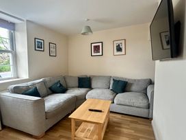 A living room with a sofa and coffee table at Mallow Cottage in Langton Matravers