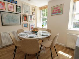 A dining room with a table and chairs at Mallow Cottage in Langton Matravers