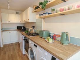 A kitchen with appliances and utensils at Mallow Cottage in Langton Matravers
