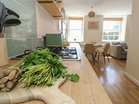 A kitchen with utensils and vegetables at Mallow Cottage in Langton Matravers
