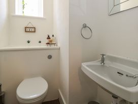A bathroom with a toilet and sink at Mallow Cottage in Langton Matravers