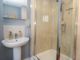 A bathroom with a shower and sink at Mallow Cottage in Langton Matravers
